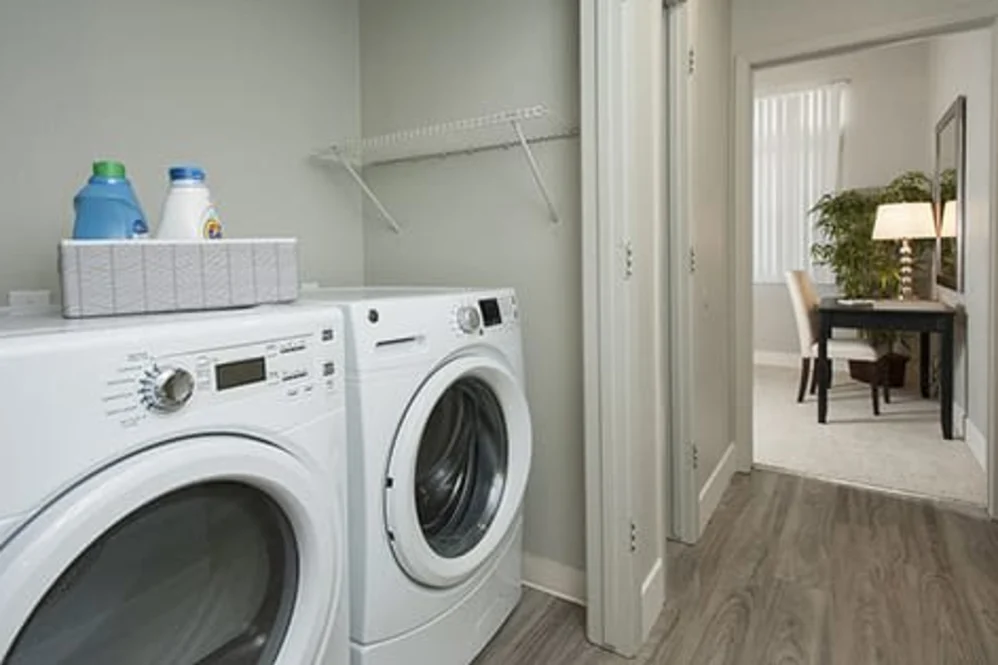 Front-loading washer and dryer in a hallway laundry nook with laminate floor