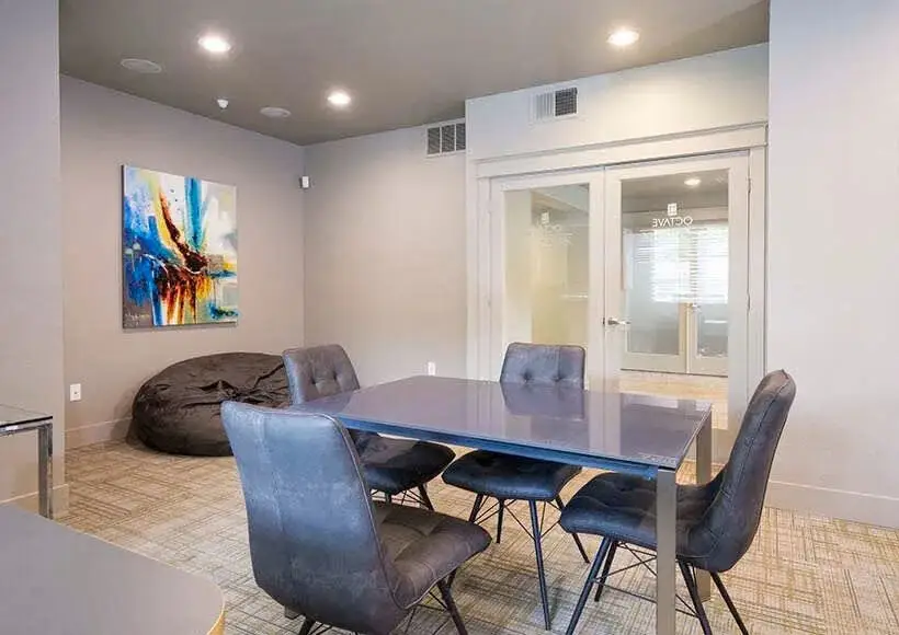 Study lounge with table, chairs, and beanbag at Octave student apartments in Davis