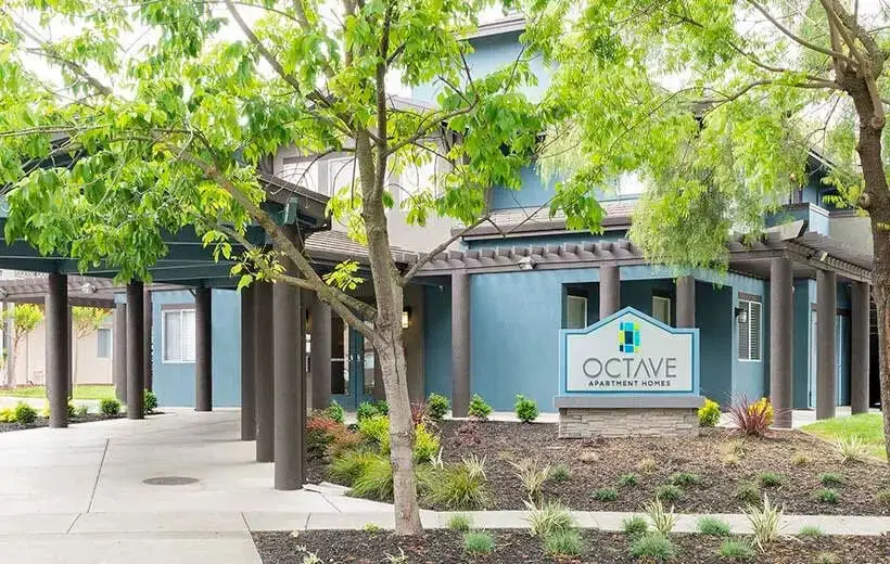 Octave Apartment Homes exterior entrance and sign with landscaping